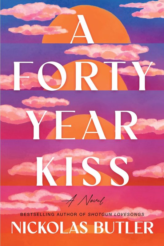 Book cover of "A Forty-Year Kiss" by Nickolas Butler, featuring two silhouetted figures standing apart on a quiet, rural road at sunset, surrounded by trees and soft golden light.