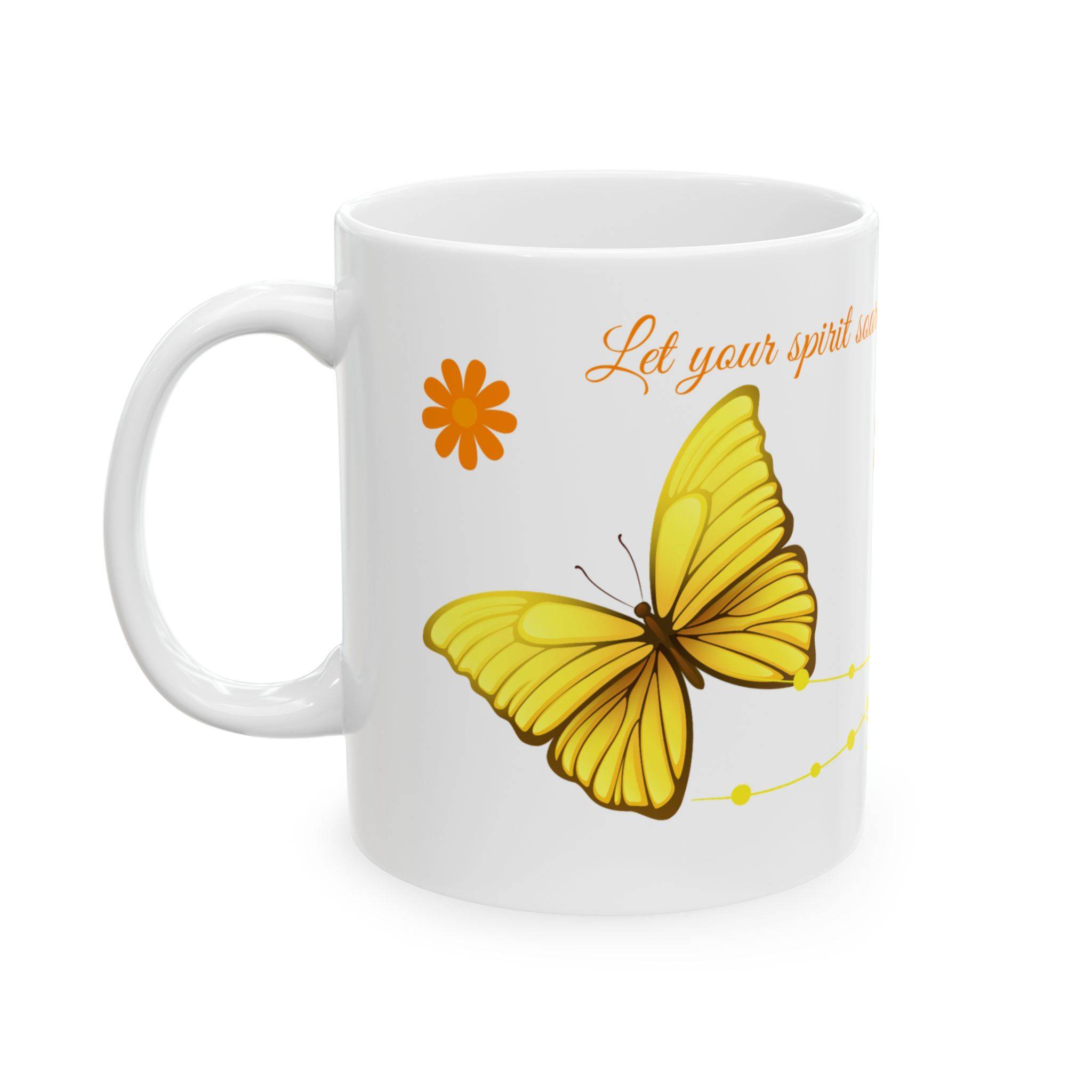 White ceramic mug with orange lettering “Let your spirit soar on wings of transformation,” decorated with yellow butterflies and orange daisy flowers.