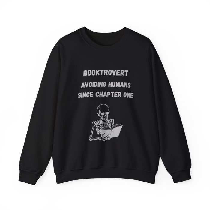 Cozy Booktrovert crewneck sweatshirt featuring a skeleton reading a book and the quote “Booktrovert – Avoiding Humans Since Chapter One” in black and white design.