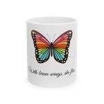 White ceramic mug with a colorful butterfly and the quote “With brave wings, she flies” in elegant typography.