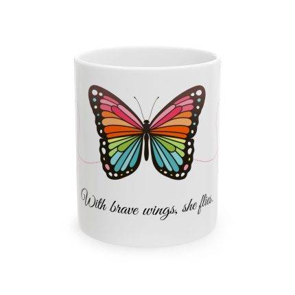 White ceramic mug with a colorful butterfly and the quote “With brave wings, she flies” in elegant typography.